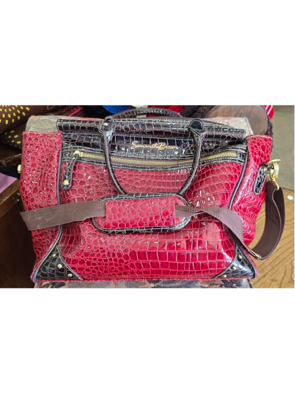 Red and black leather duffel bag with bathroom bag